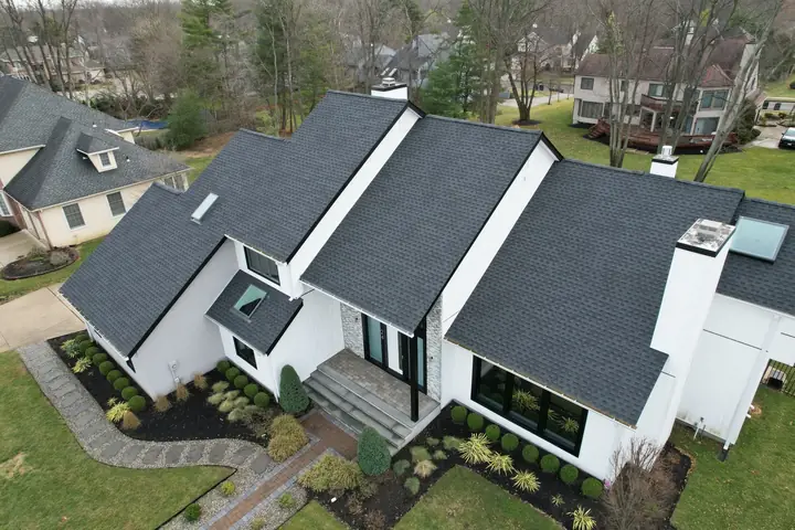Multi-plane charcoal roof on a modern white home