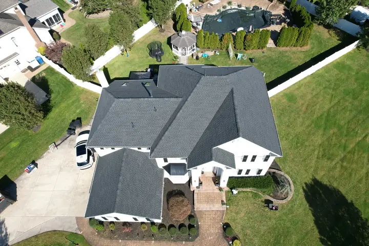 Black architectural roof on a white two-story home