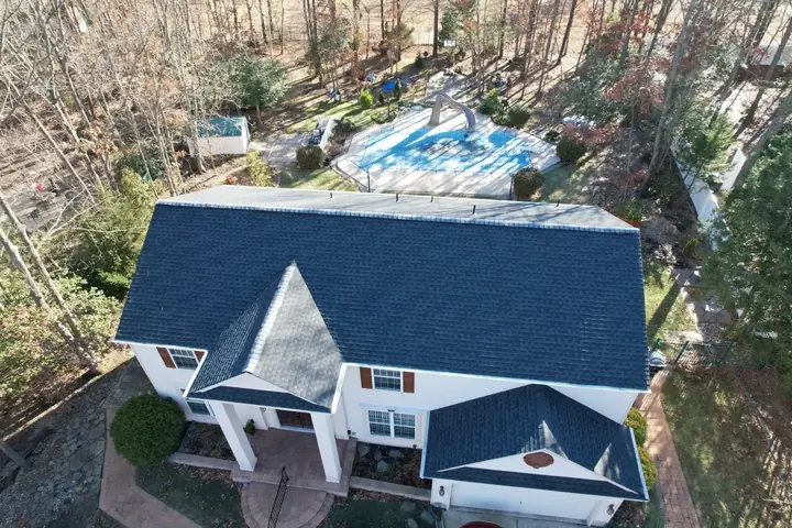 Finished black roof on a wooded two-story home