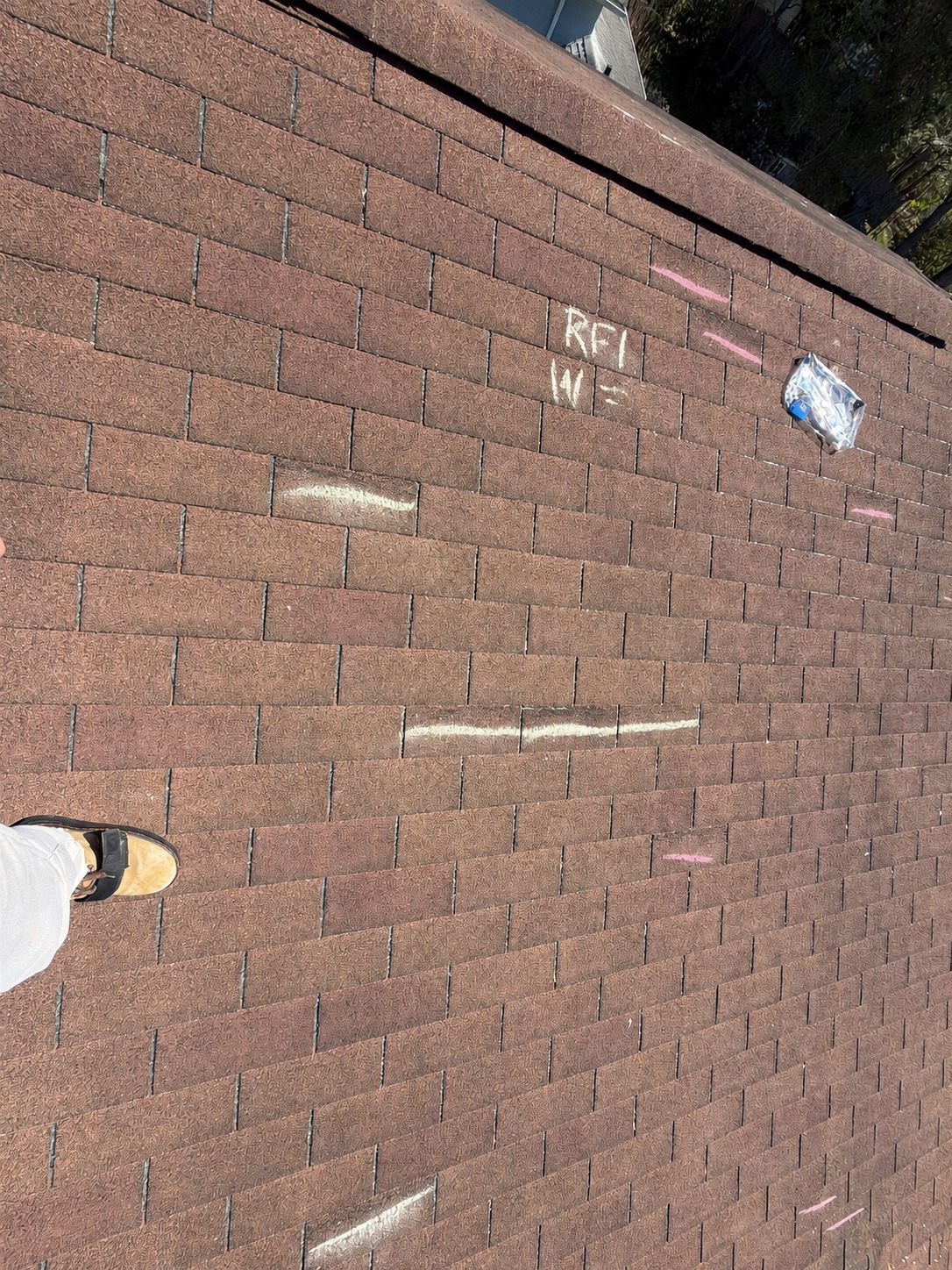 Roof inspection with chalk marks identifying areas for closer evaluation